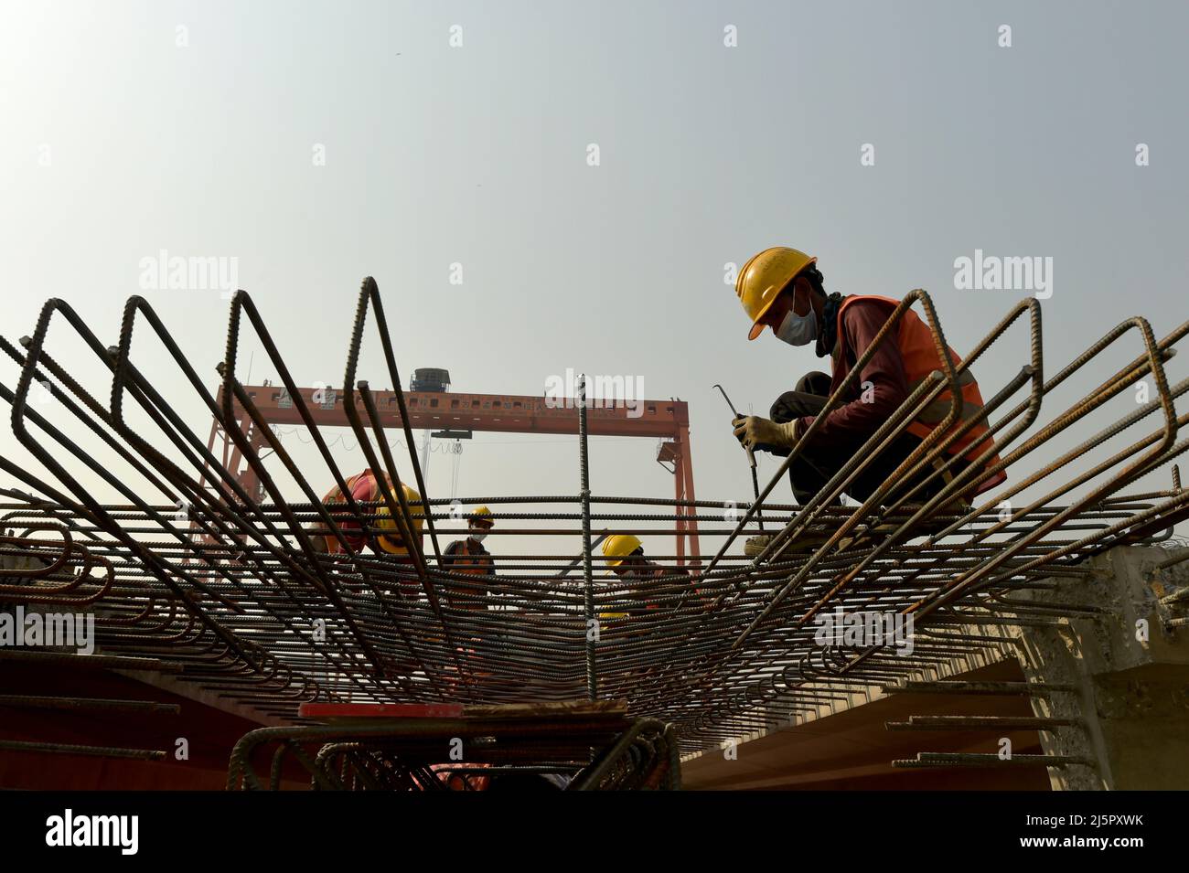 Dhaka. 25th Apr, 2022. Workers tie rebar cages for the First Dhaka Elevated Expressway (FDEE) in Dhaka, Bangladesh, March 17, 2022. TO GO WITH 'Feature: Fast and safe, Sino-Bangladeshi expressway joint venture sees clear road ahead' Credit: Xinhua/Alamy Live News Stock Photo