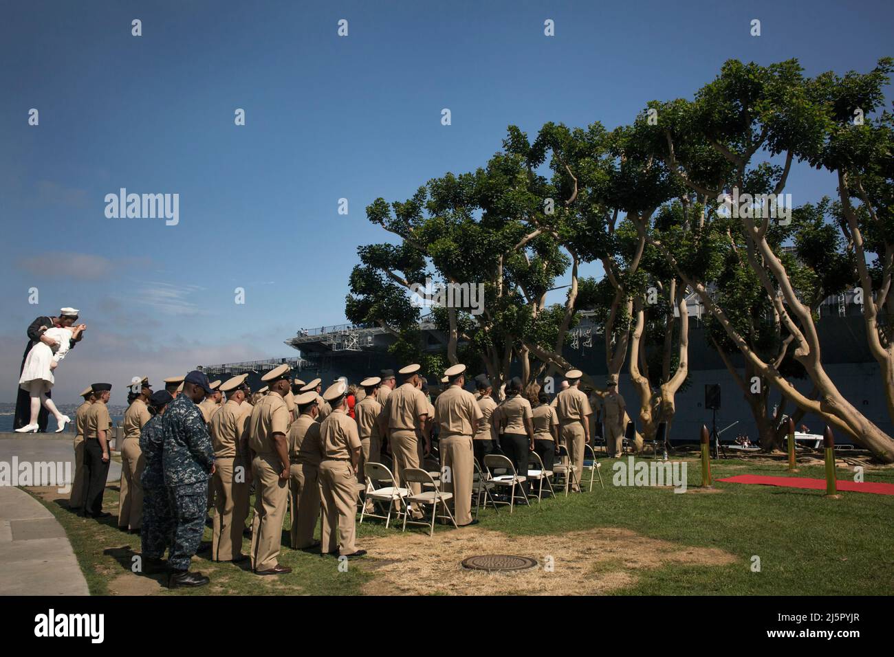 Patriotic homage ceremony of Navy veterans by the Embracing peace sculpture in San Diego Navy Pier Stock Photo