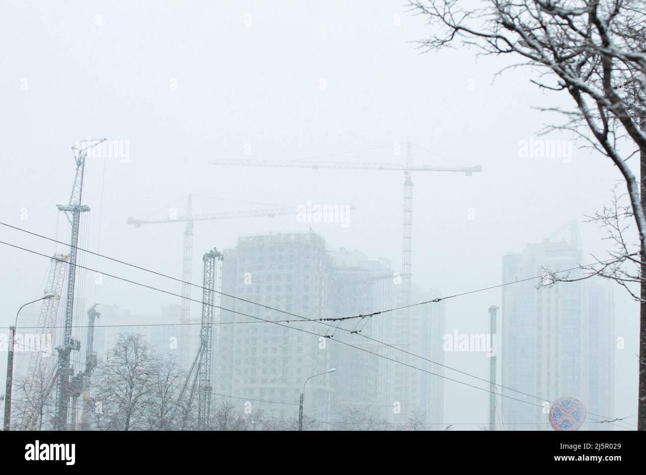 skyscrapers in the background covered in snow during a winter snowstorm Stock Photo