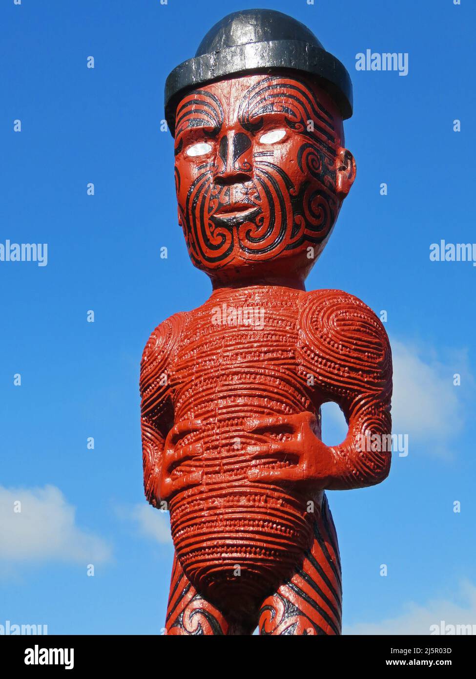 Traditional Maori wood carving or statue at Whakarewarewa park, Rotorua. Stock Photo