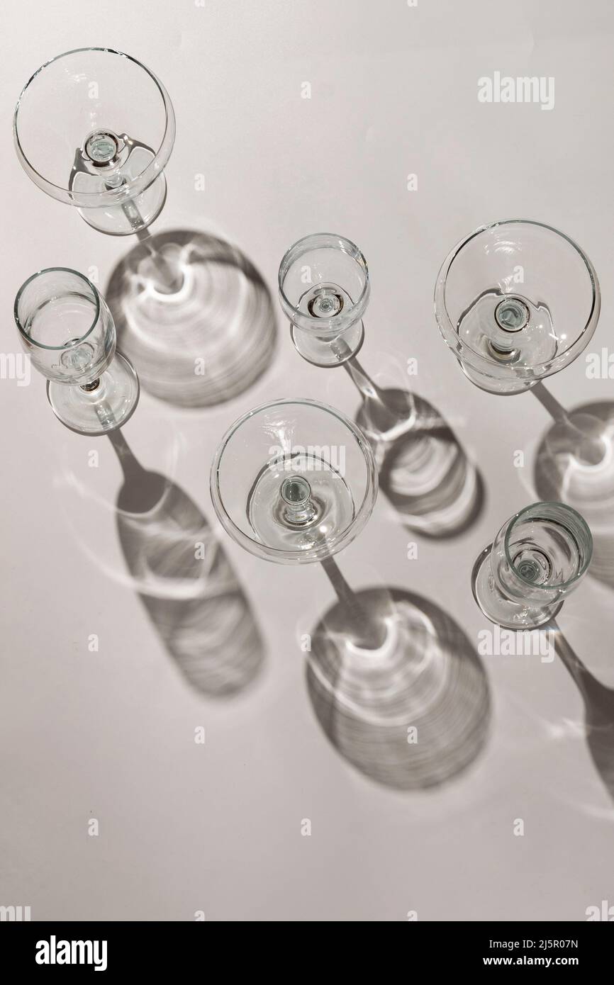 Cocktail glasses with long shadows on the table Stock Photo