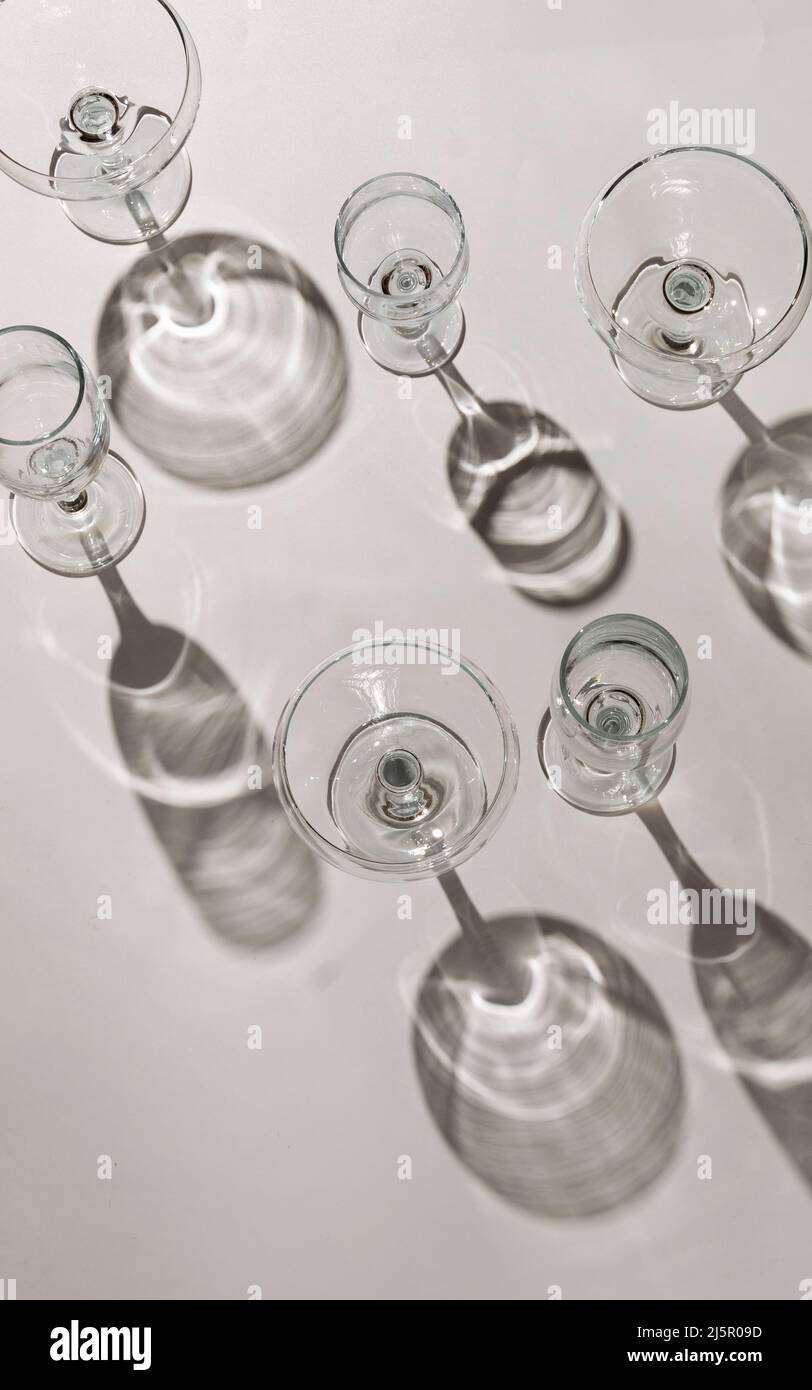 Cocktail glasses with long shadows on the table Stock Photo