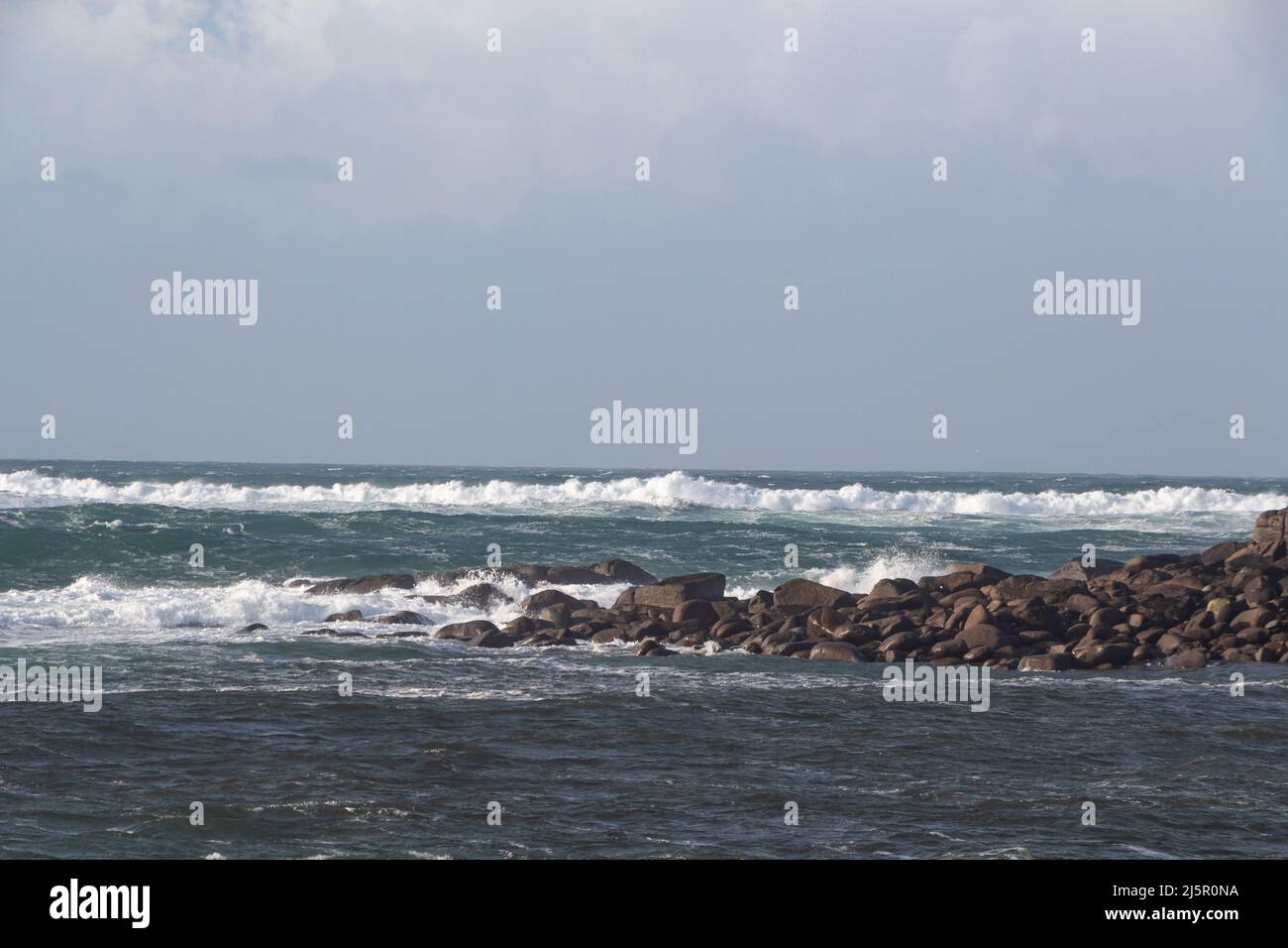 Coast in Brittany with waves crushing on rocks Stock Photo - Alamy