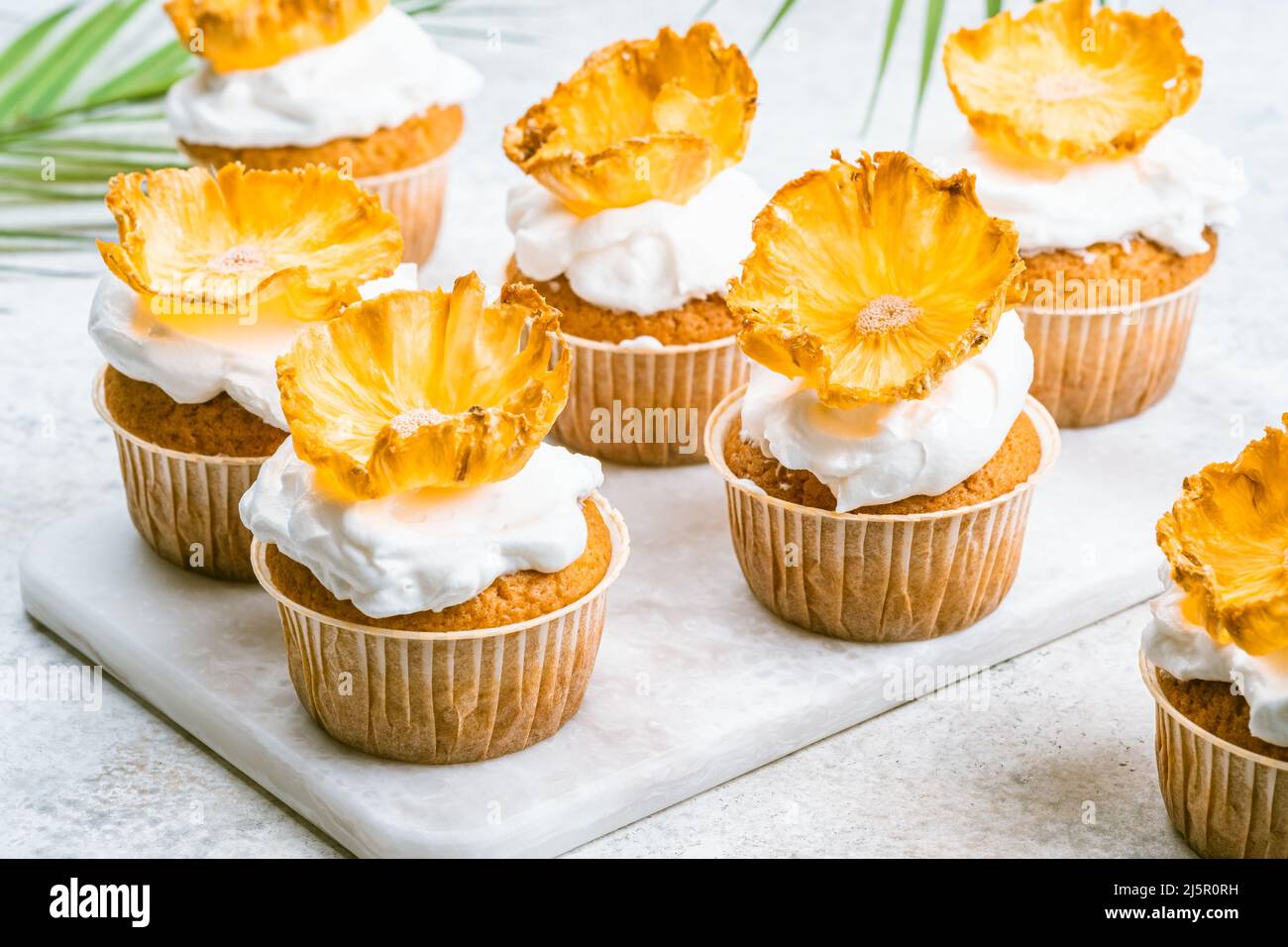 Cupcakes with dried pineapple flowers Stock Photo