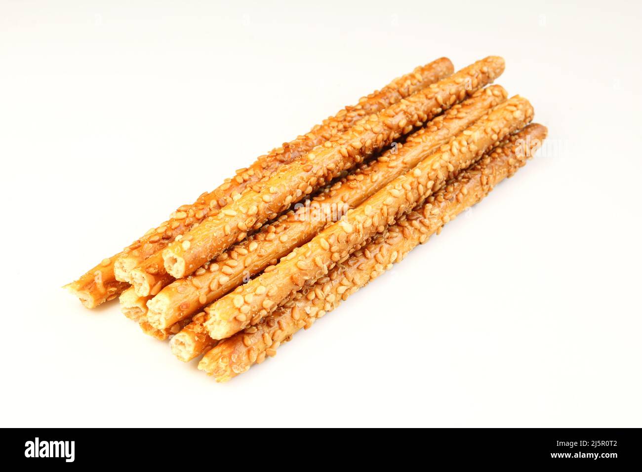 Stack of wheat sticks with sesame seeds idolated on white background Stock Photo