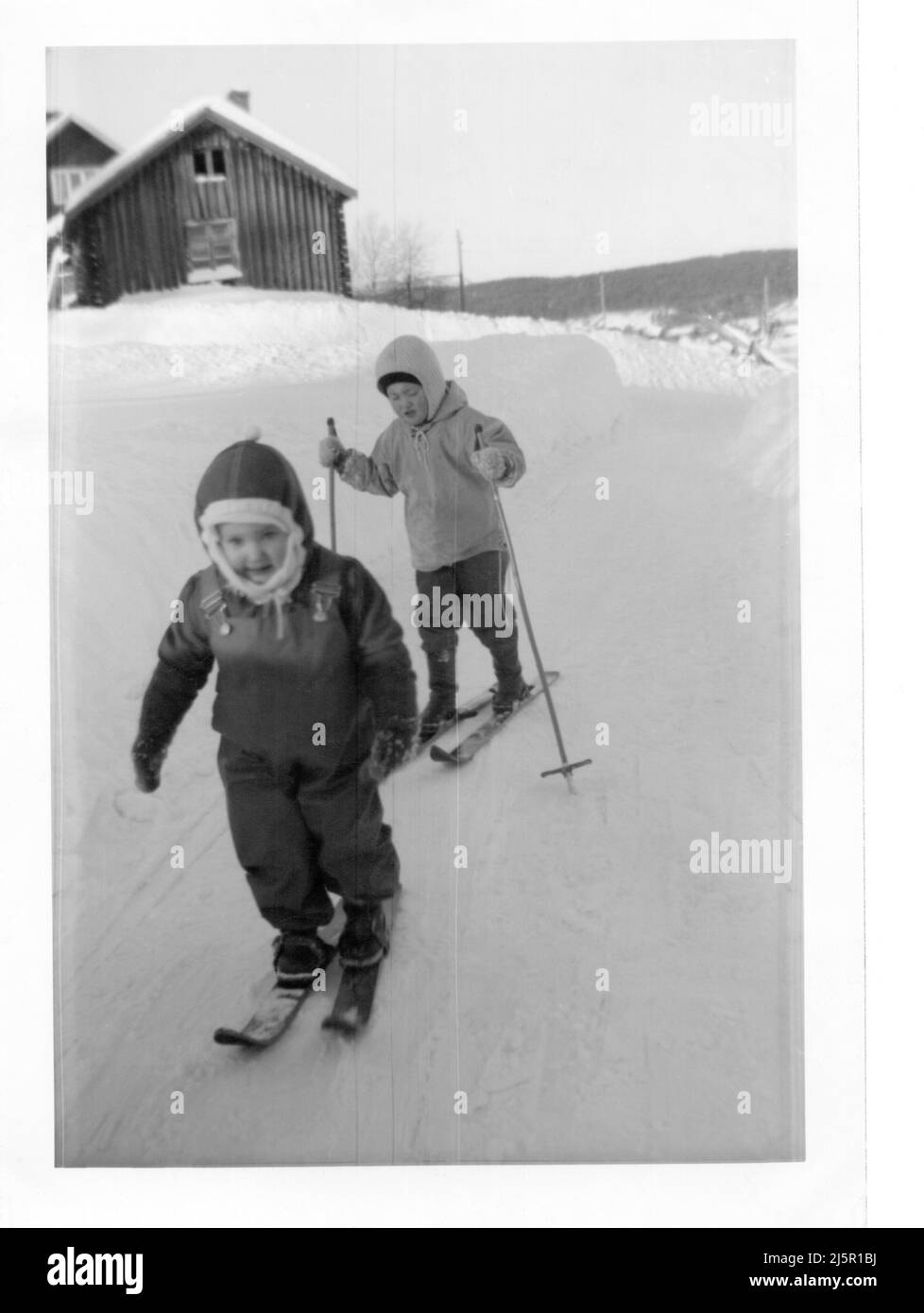 1960's authentic vintage photograph of two children skiing, Sweden Stock Photo