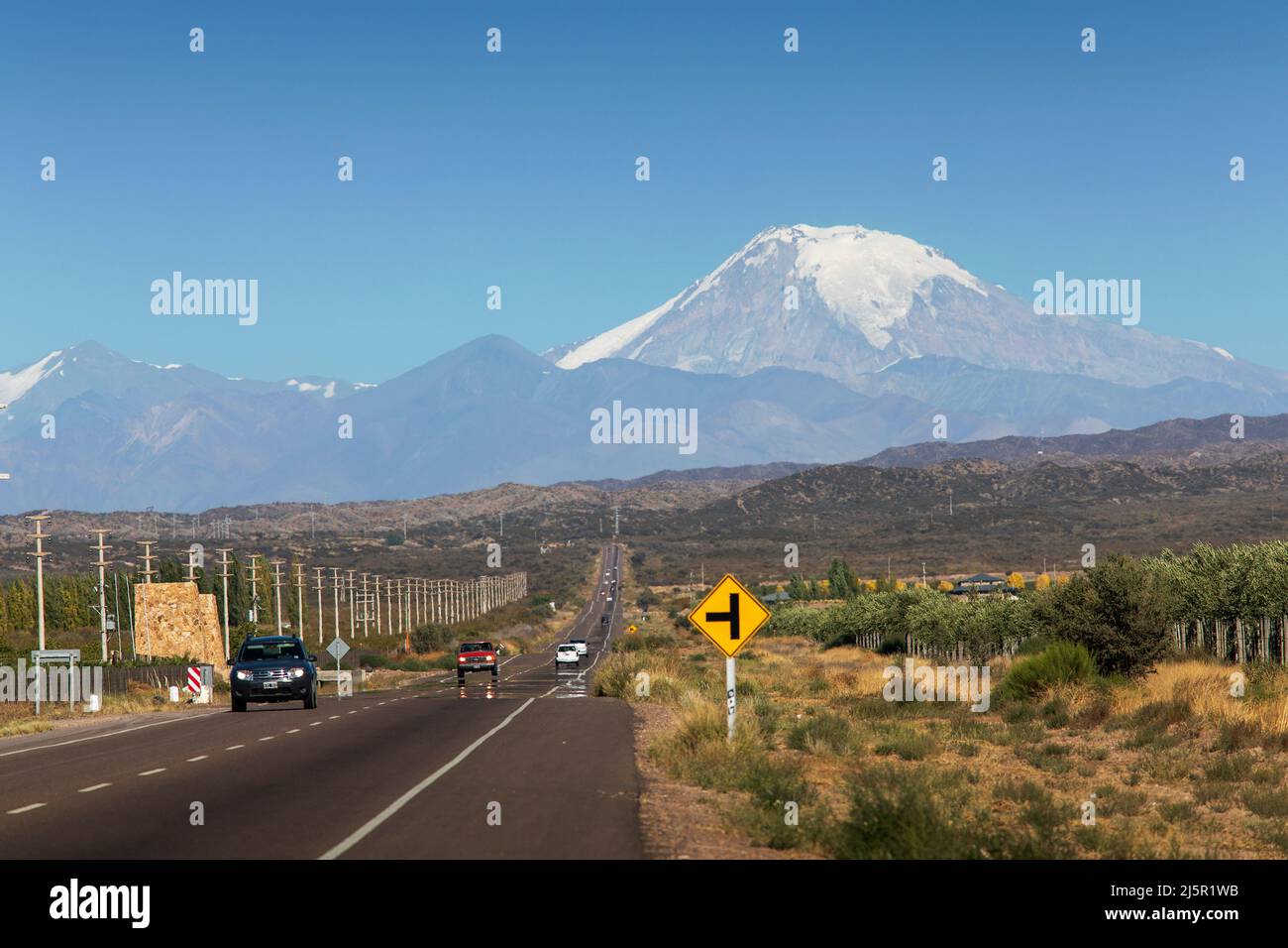 Highway through Argentinian Uco valley with the snowy Andes mountains in the back. Stock Photo