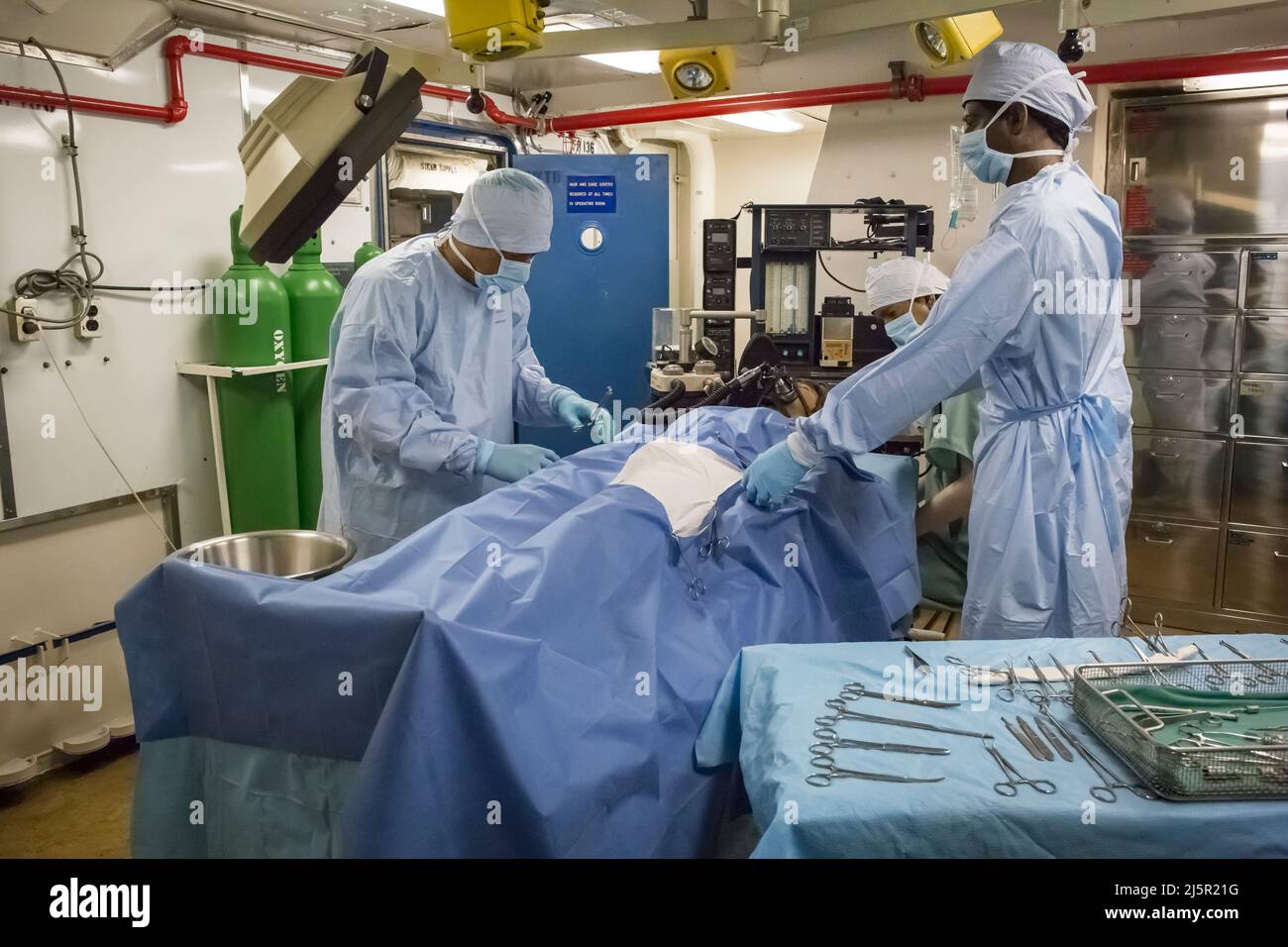 Two fake doctors and a nurse operating on a patient in the sick bay and hospital of the USS Midway aircraft carrier, San Diego Navy Pier Stock Photo