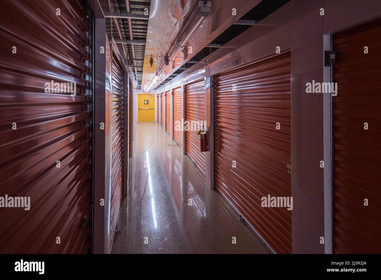 Inside dark self storage facility Stock Photo