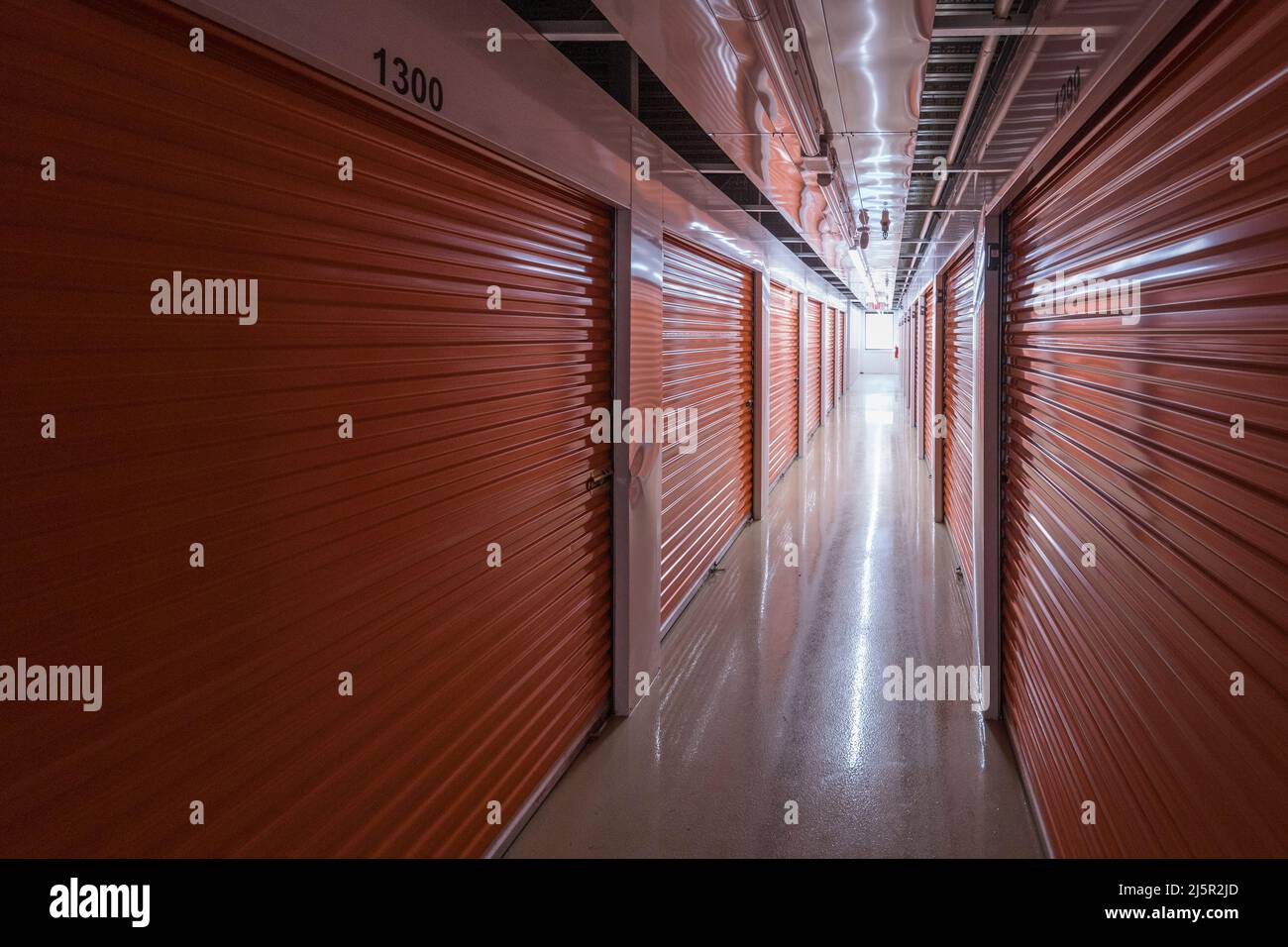 Inside dark self storage facility Stock Photo