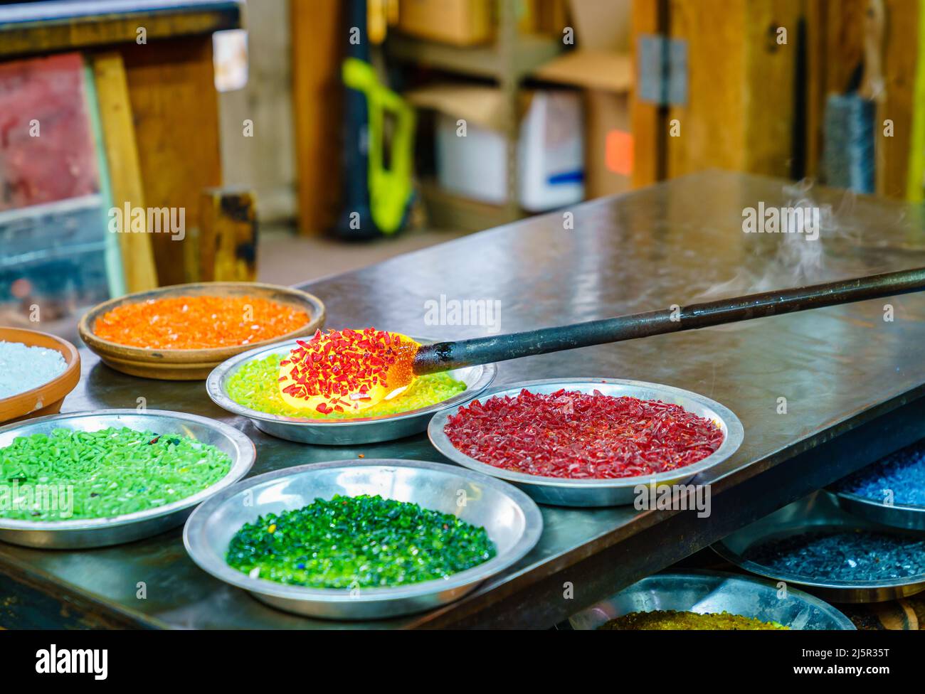 Jars of pulled cane and frit glass blowing supplies Stock Photo - Alamy