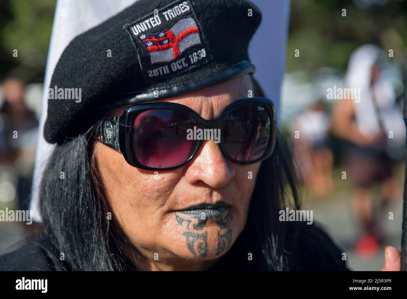Maori female member of the United Tribes organisation in a protest march during Waitangi day. Waitangi Day is the national day of New Zealand, and com Stock Photo
