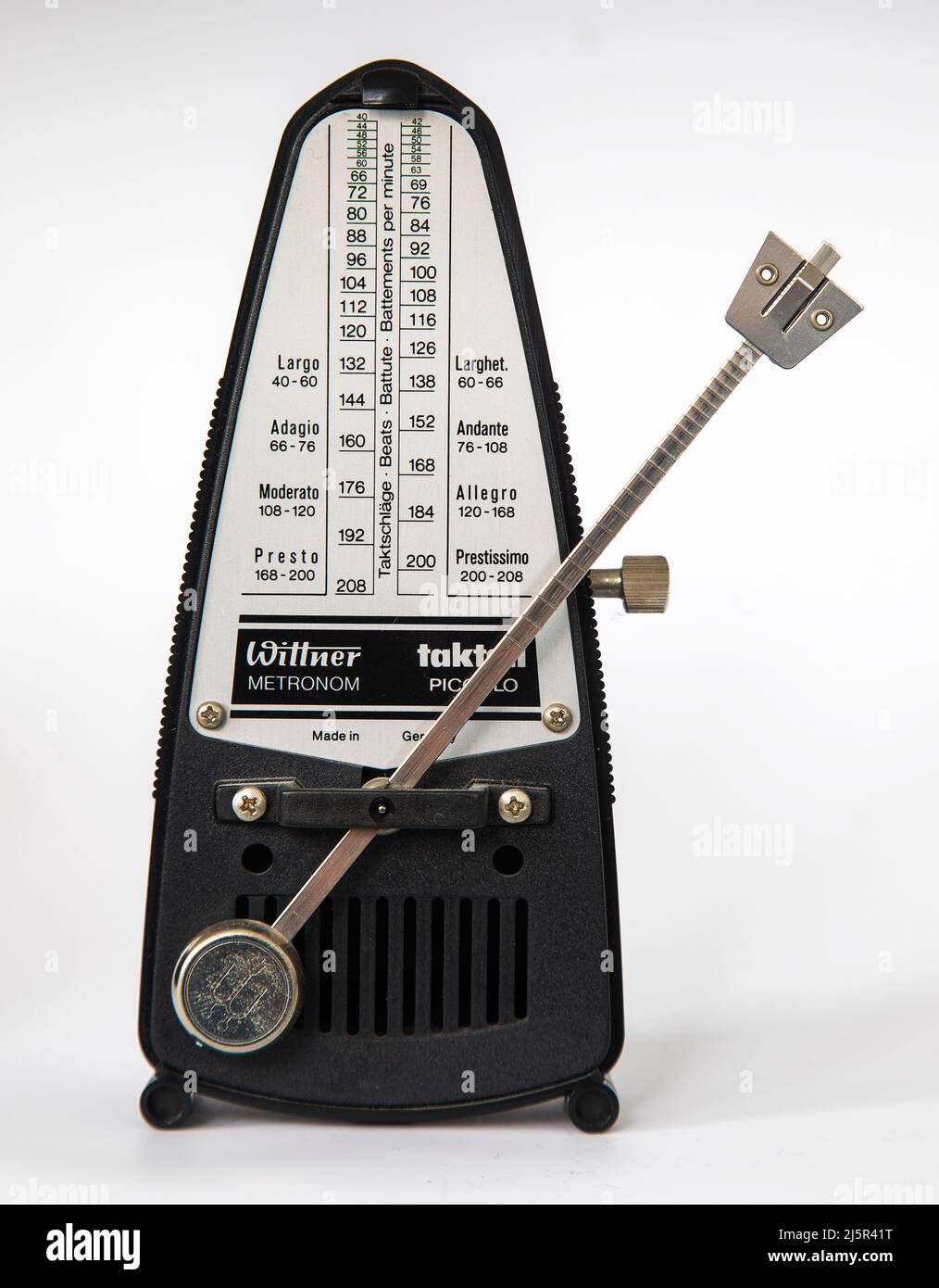 A metronome is a device that produces an audible click or other sound at a  regular interval that can be set by the user, typically in beats per minute  Stock Photo 