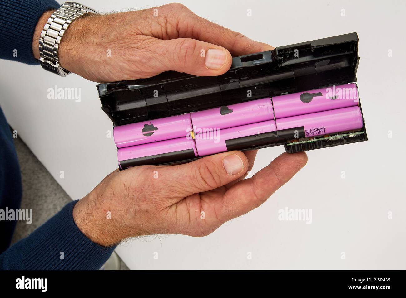 Lithium-ion batteries are common in home electronics, like a laptop. A lithium-ion battery or Li-ion battery is a type of rechargeable battery in whic Stock Photo