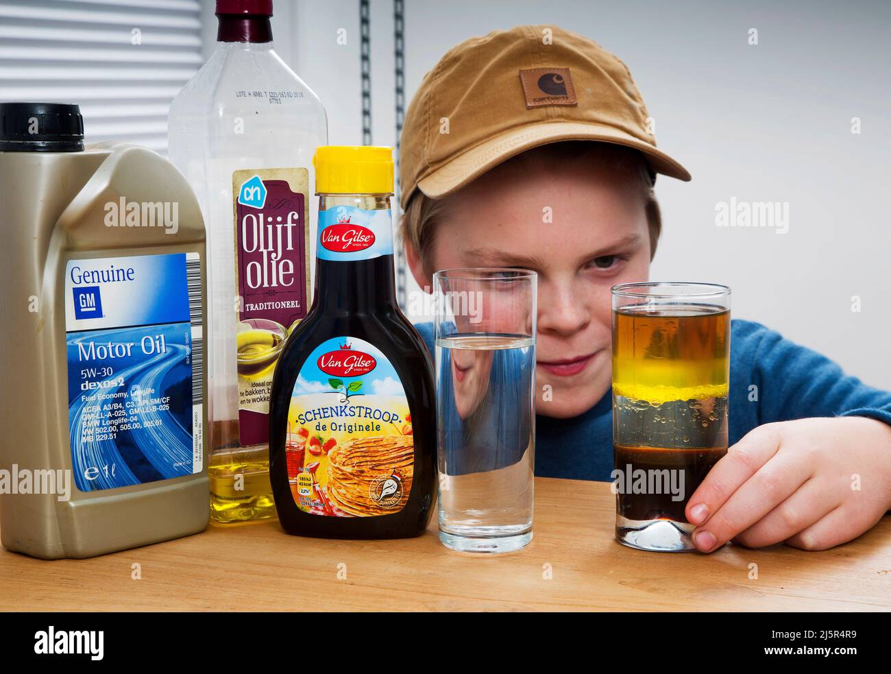 To show the density of liquids this boy has poored different liquids in