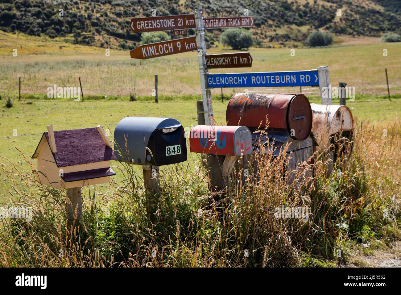 New Zealand, Kinloch and Glenorchy area on South Island - Mail box and distance signs in this rural area. Stock Photo