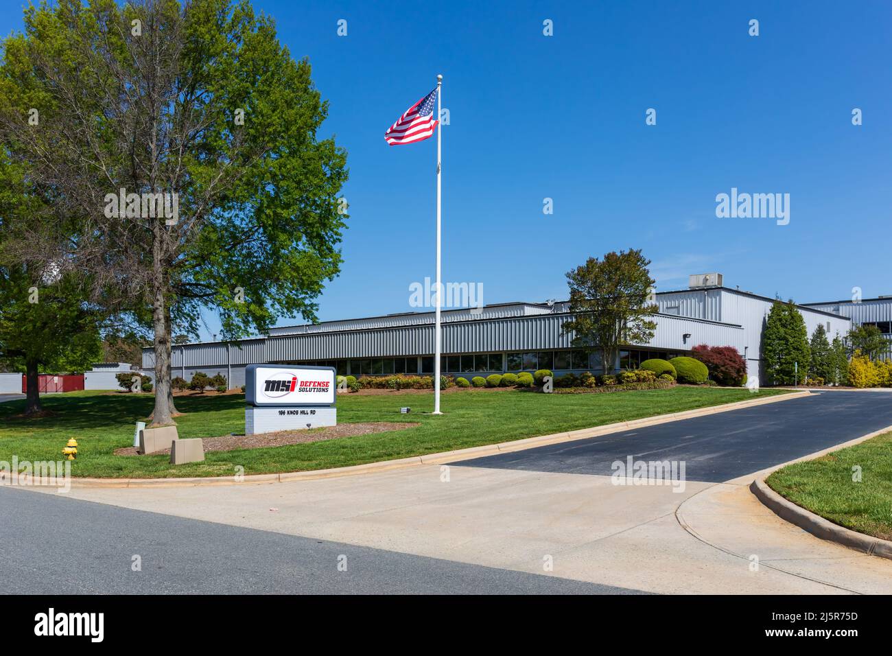 MOORESVILLE, NC, USA-17 APRIL 2022: MSI Defense Solutions, engineering for military vehicles. Building, flag and monument sign. Stock Photo