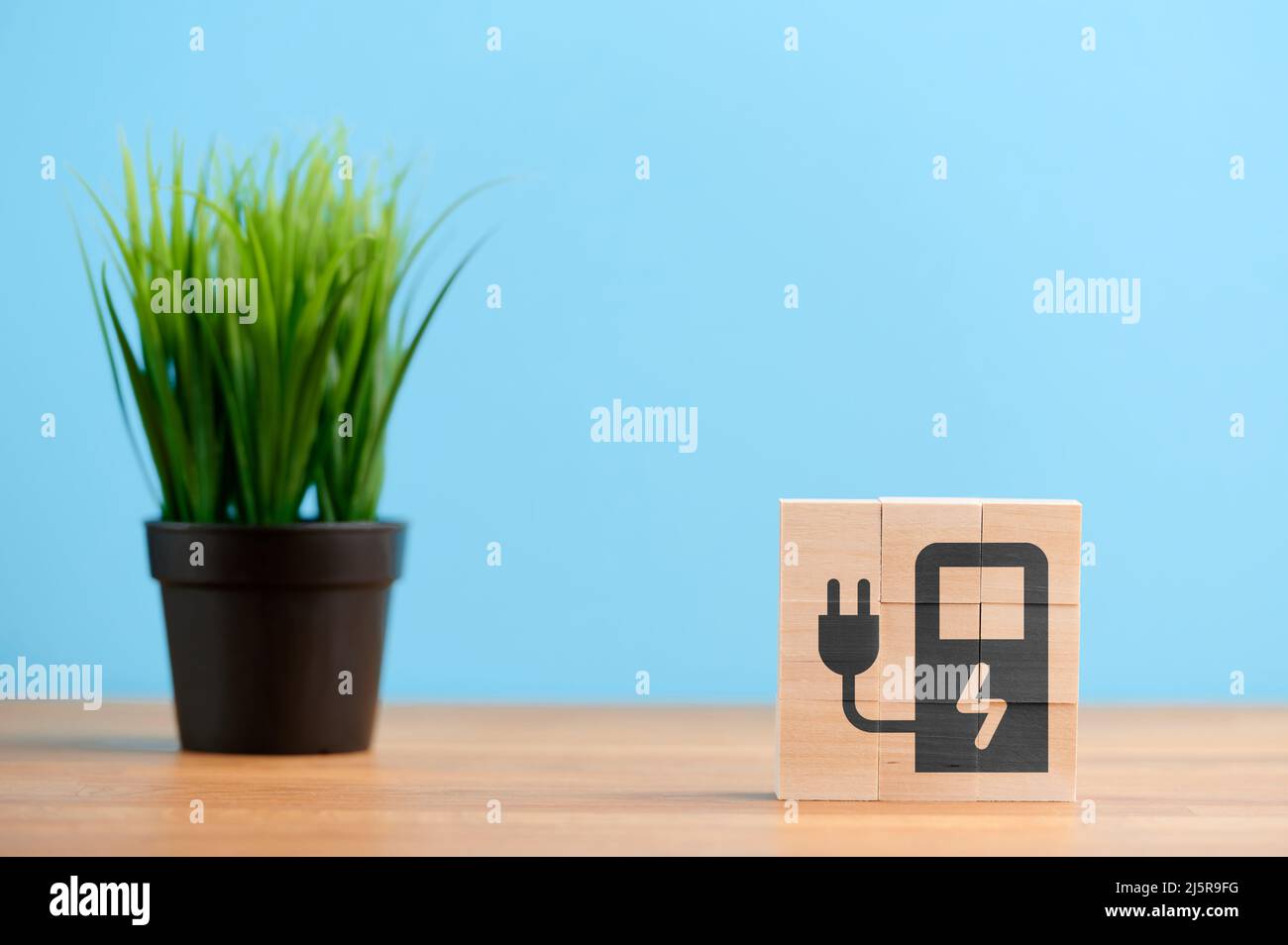 Wooden blocks with symbol of energy charging station, eco power