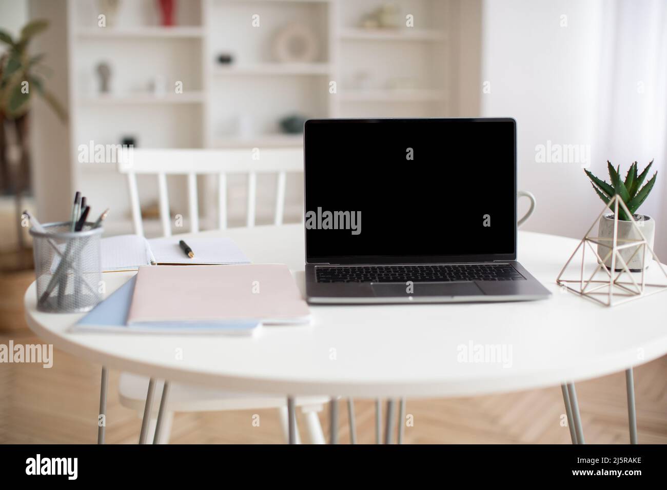 Laptop Computer With Empty Screen Standing On Table At Home Stock Photo