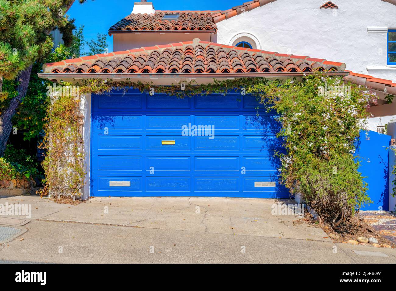 Garage of a mediterranean house with blue sectional garage door and