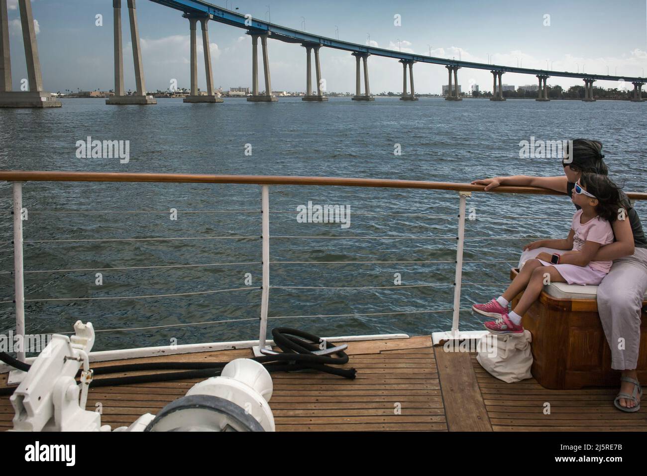 Mother and child contemplating Coronado Bridge from a sightseeing cruise through San Diego South Bay Stock Photo