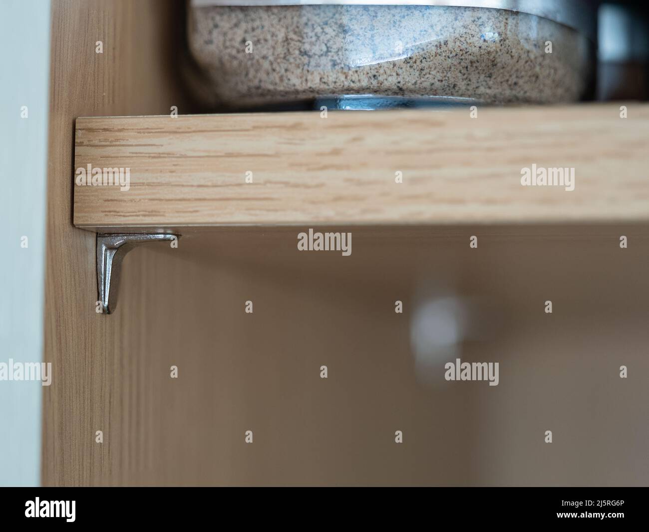 selected focus close up of a kitchen chromed steel shelf