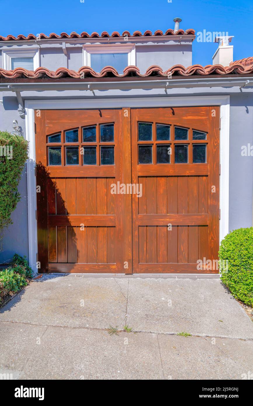 Sidehinged wooden garage door with glass window panels at San Francisco, California Stock Photo