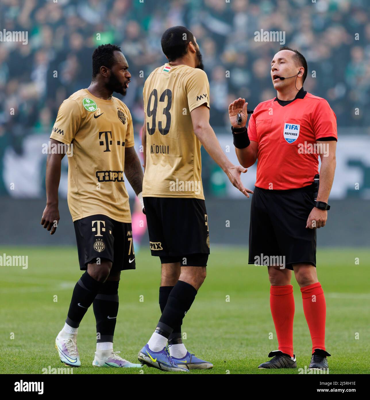 BUDAPEST, HUNGARY - APRIL 24: Referee Ferenc Karako gives an explanation for Aissa Laidouni of Ferencvarosi TC #93 and Franck Boli of Ferencvarosi TC during the Hungarian OTP Bank Liga match between Ferencvarosi TC and Ujpest FC at Groupama Arena on April 24, 2022 in Budapest, Hungary. Stock Photo
