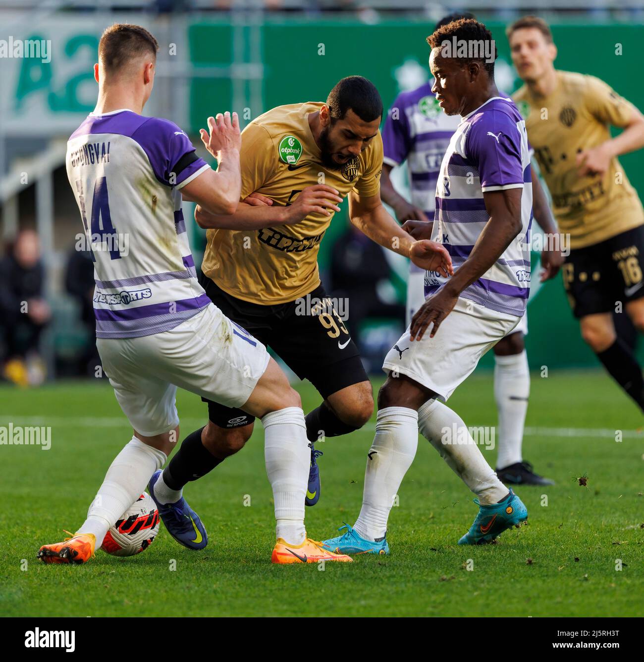 BUDAPEST, HUNGARY - APRIL 24: Aissa Laidouni of Ferencvarosi TC fights for the ball with Aron Csongvai of Ujpest FC (l) and Vincent Onovo of Ujpest FC during the Hungarian OTP Bank Liga match between Ferencvarosi TC and Ujpest FC at Groupama Arena on April 24, 2022 in Budapest, Hungary. Stock Photo