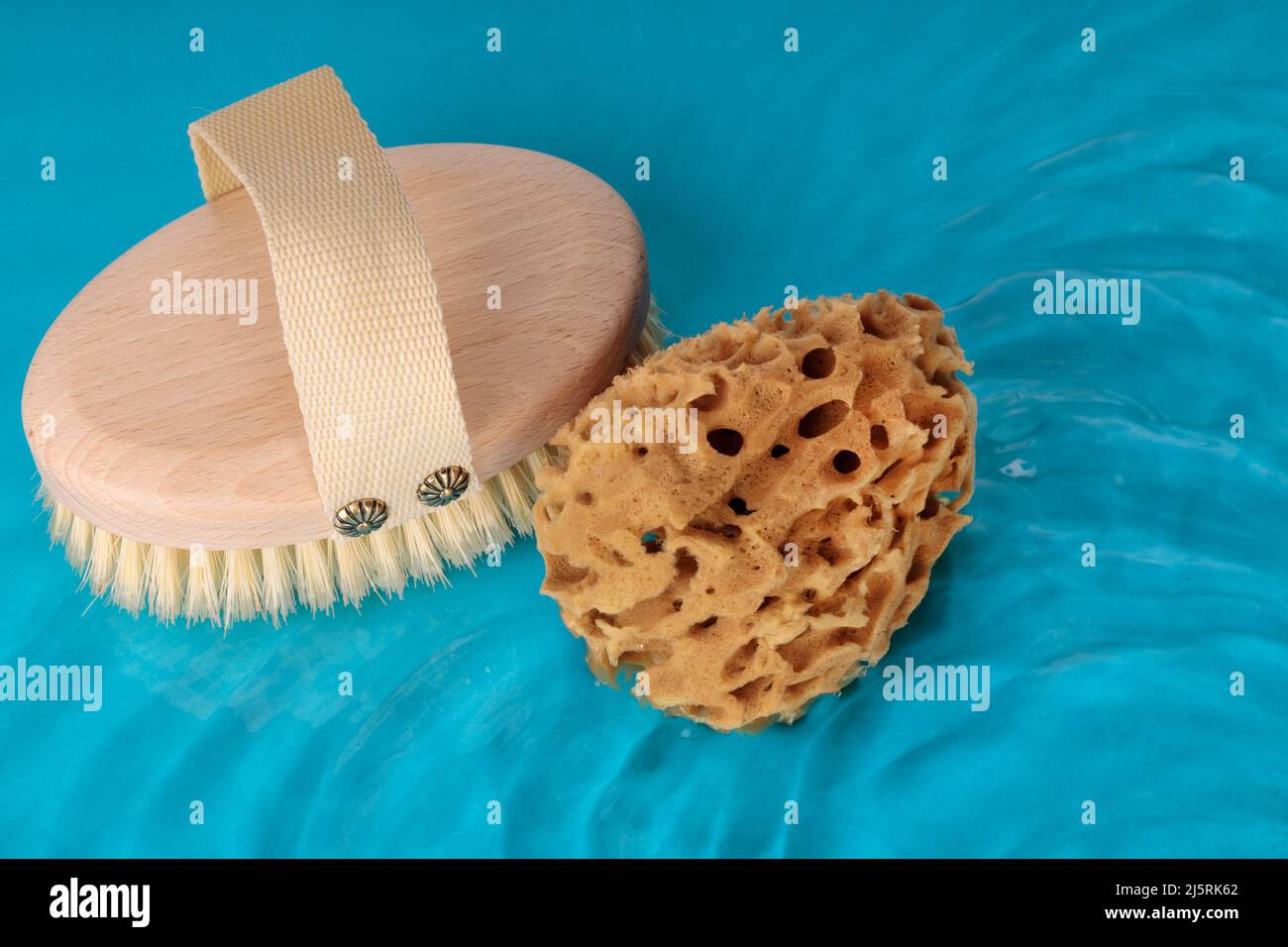 Wooden brush made of natural material and natural sponge. Bathroom treatments. Home body care. Conceptual image Stock Photo