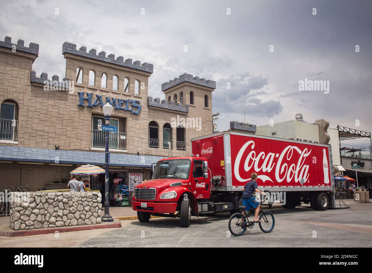 Coca-cola truck parked in front of the castle-shaped Hamel’s Surf shop in Mission Bay, San Diego Stock Photo