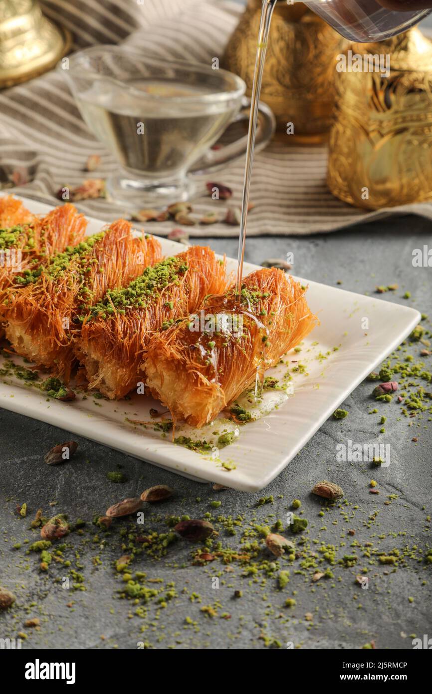 Homemade arabian traditional sweets Kunafa or konafa roll with cheese