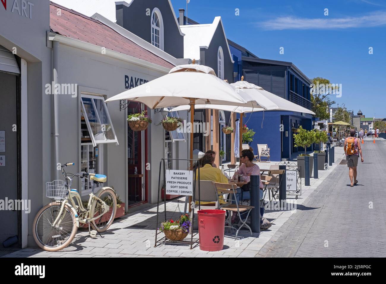 Western tourists at bakery in the main street of the town Hermanus, Overstrand, Overberg, Western Cape Province, South Africa Stock Photo