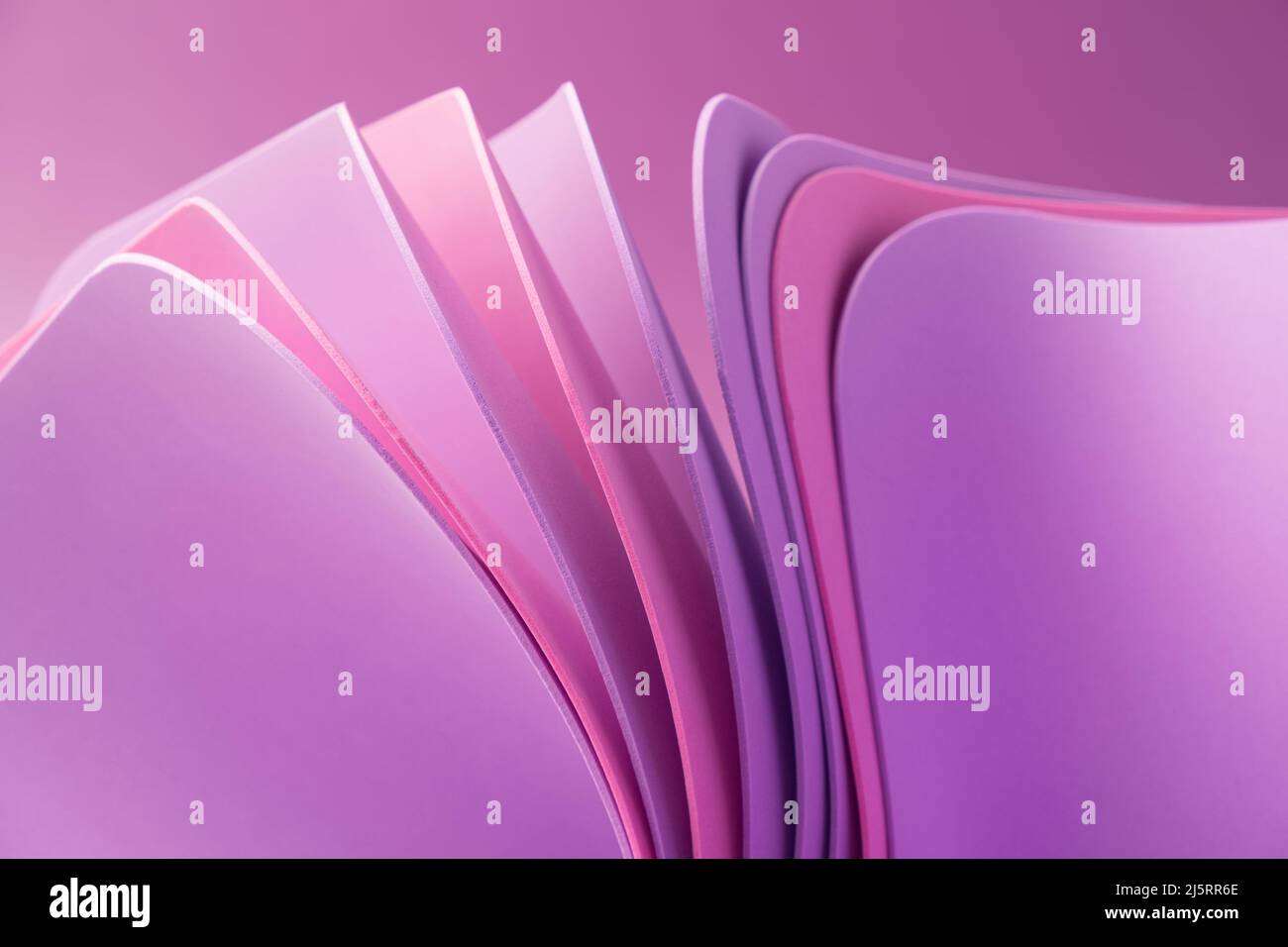 Violet pastel wavy paper sheets on a purple background. Abstract colorful backdrop Stock Photo