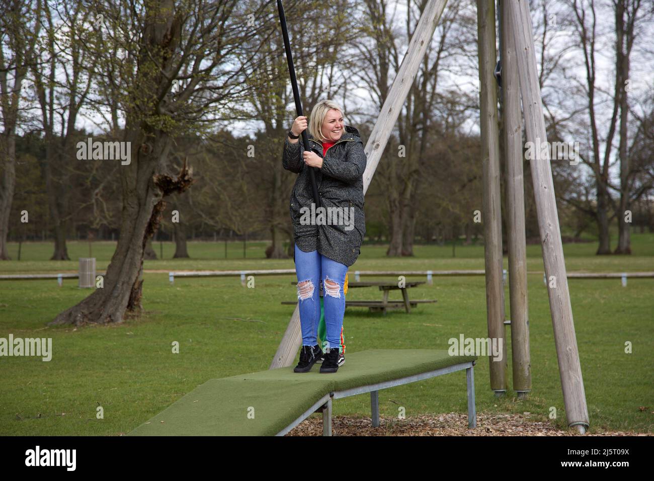 An adult female going on a zip wire ride, UK Stock Photo
