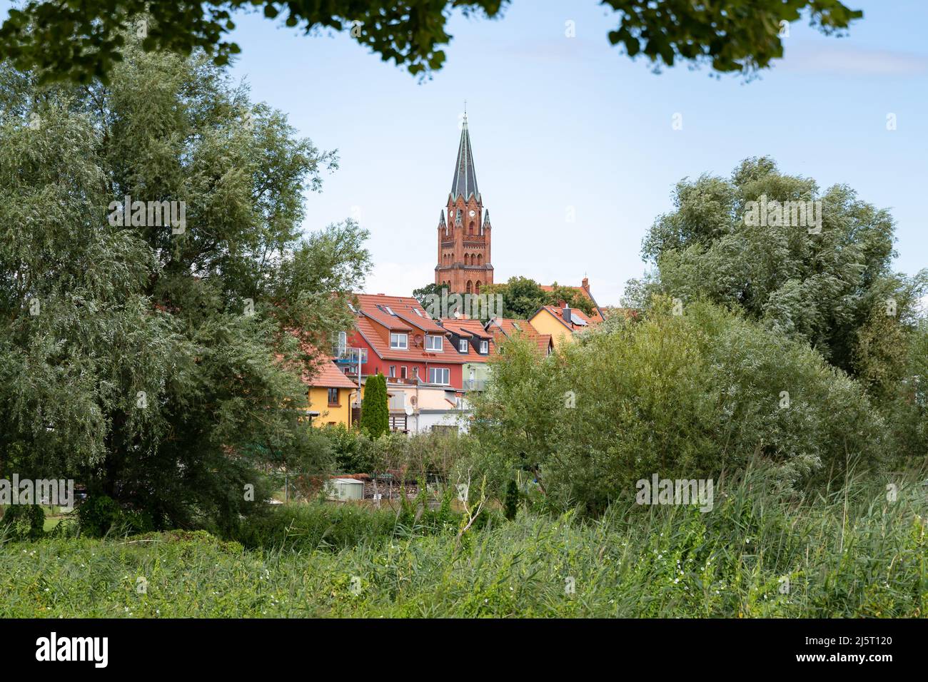Landscape of Röbel Müritz when looking at the city center. The tower of the church is visible at the horizon. A skyline of a small town in Germany. Stock Photo