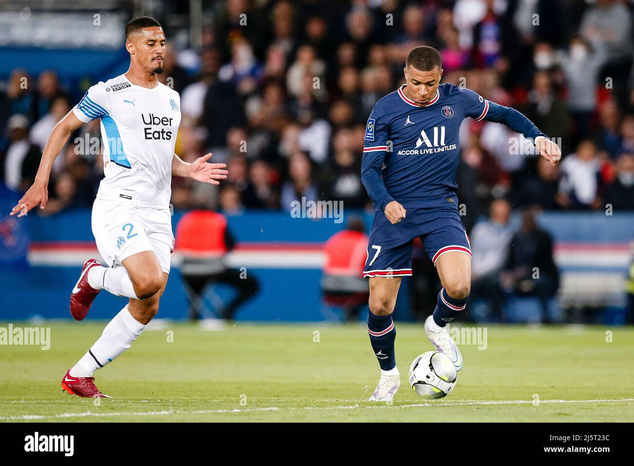 Paris, France - April 17: Kylian Mbappe of Paris Saint Germain (R) attempts a kick after dribbling William Saliba of Marseille (L) during the Ligue 1 Stock Photo