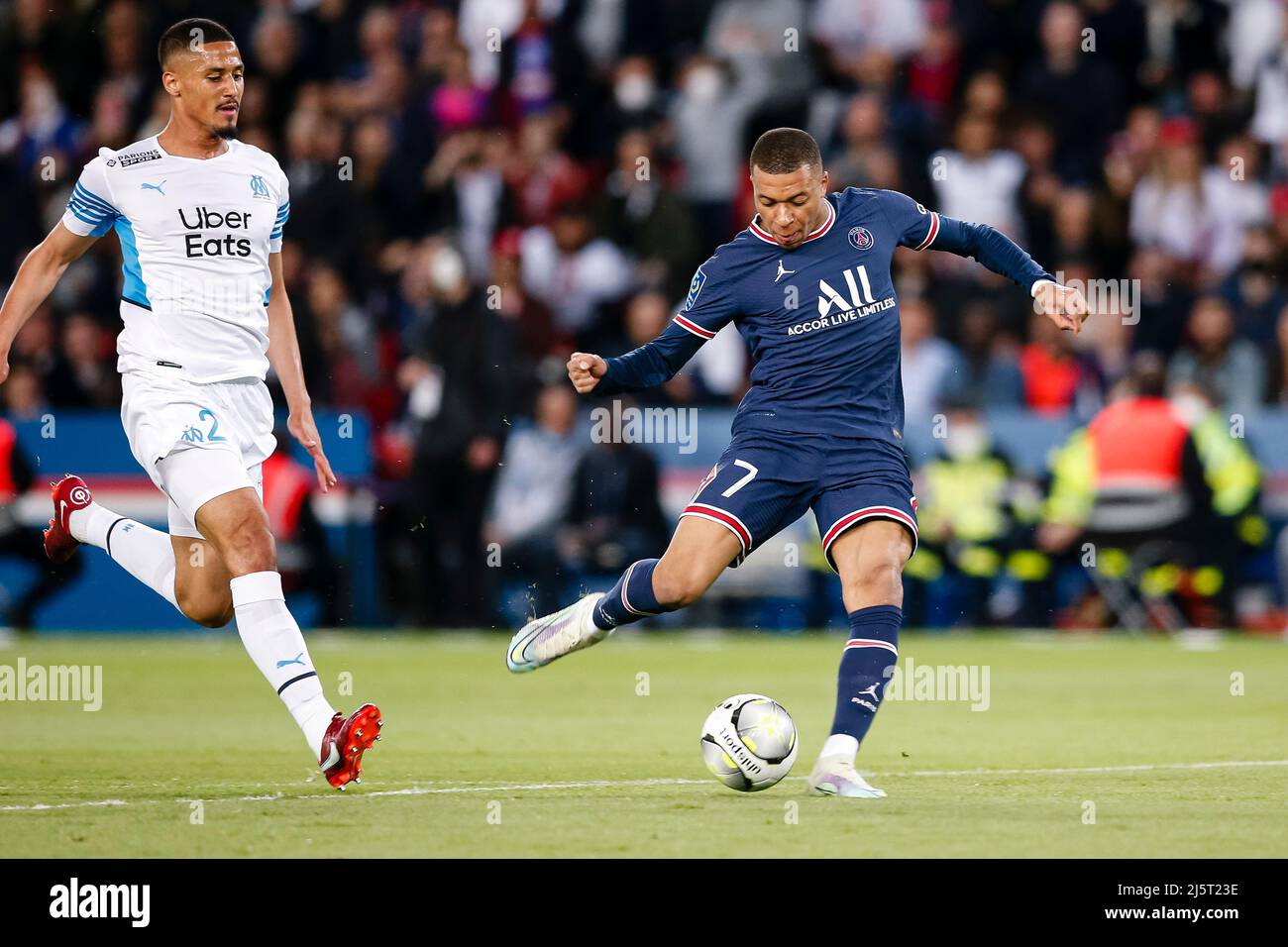 Paris, France - April 17: Kylian Mbappe of Paris Saint Germain (R) attempts a kick after dribbling William Saliba of Marseille (L) during the Ligue 1 Stock Photo
