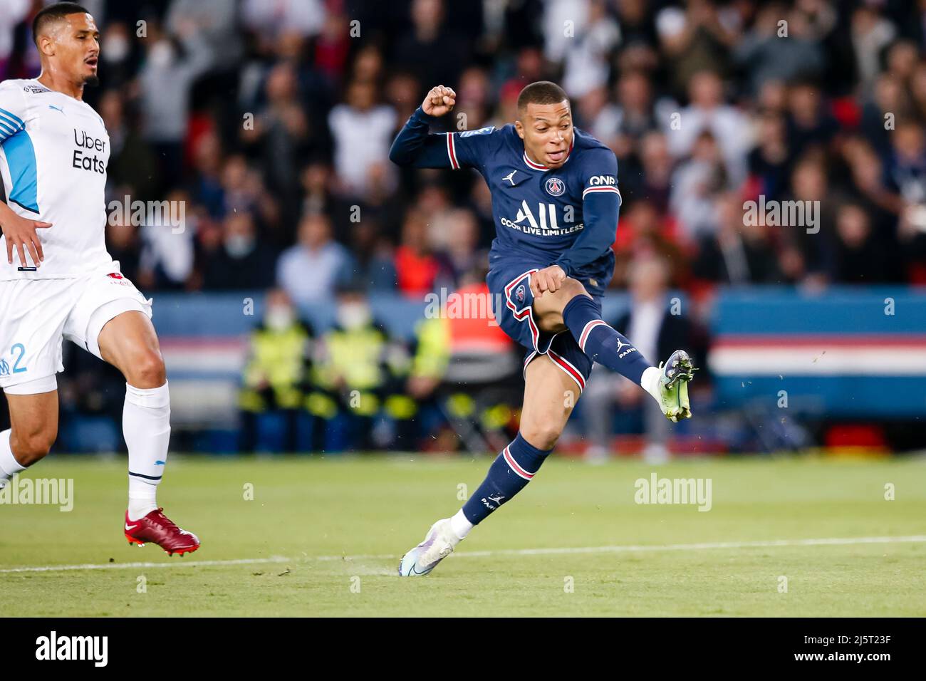 Paris, France - April 17: Kylian Mbappe of Paris Saint Germain (R) attempts a kick after dribbling William Saliba of Marseille (L) during the Ligue 1 Stock Photo