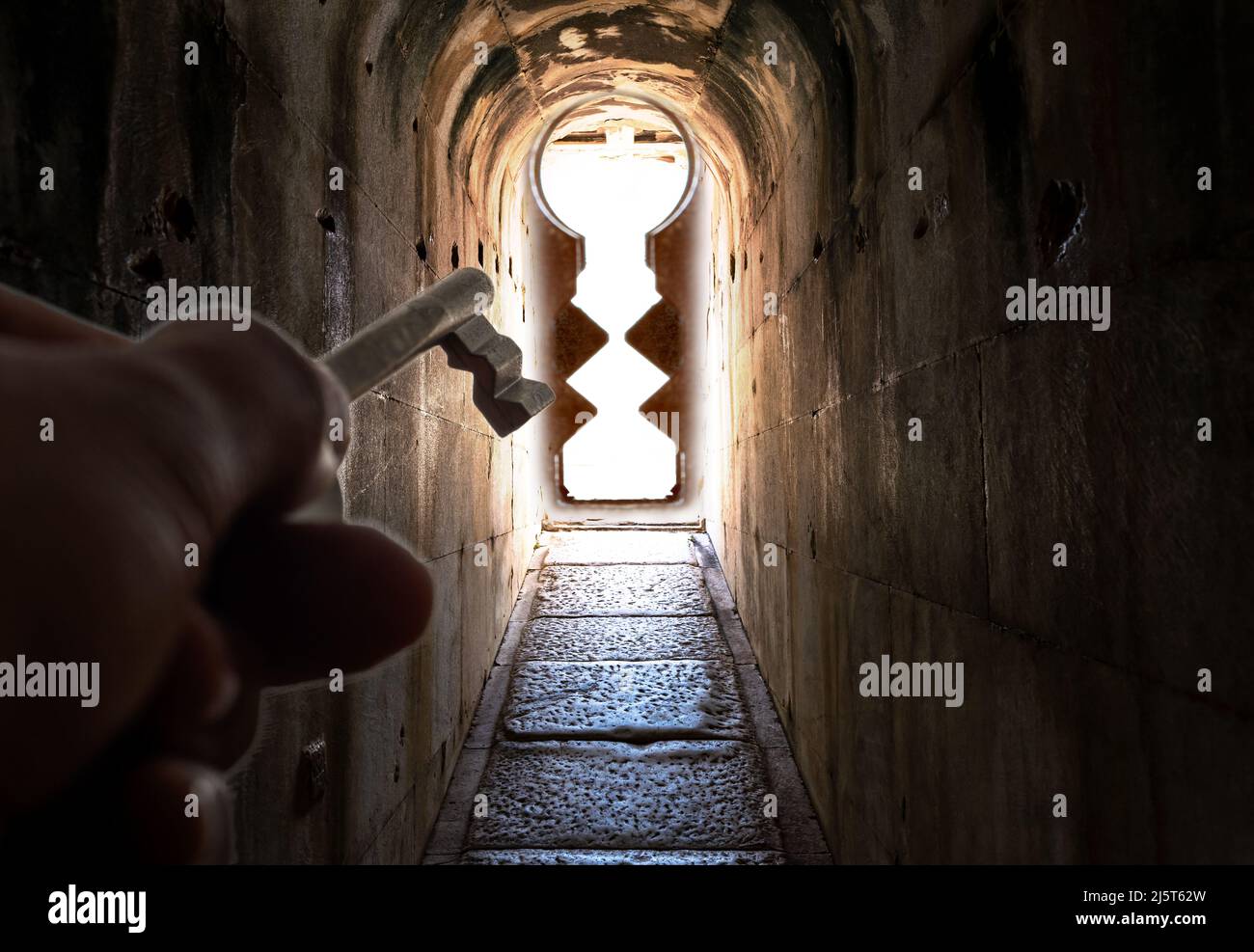 Narrow dark corridor and and keyhole. Concept of problem solving ability. Stock Photo