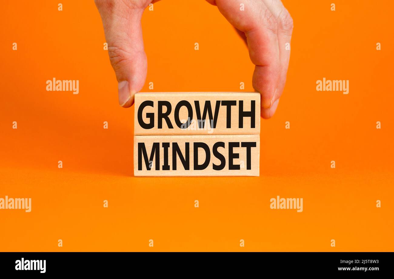 Growth mindset symbol. Wooden blocks with concept words Growth mindset on beautiful orange