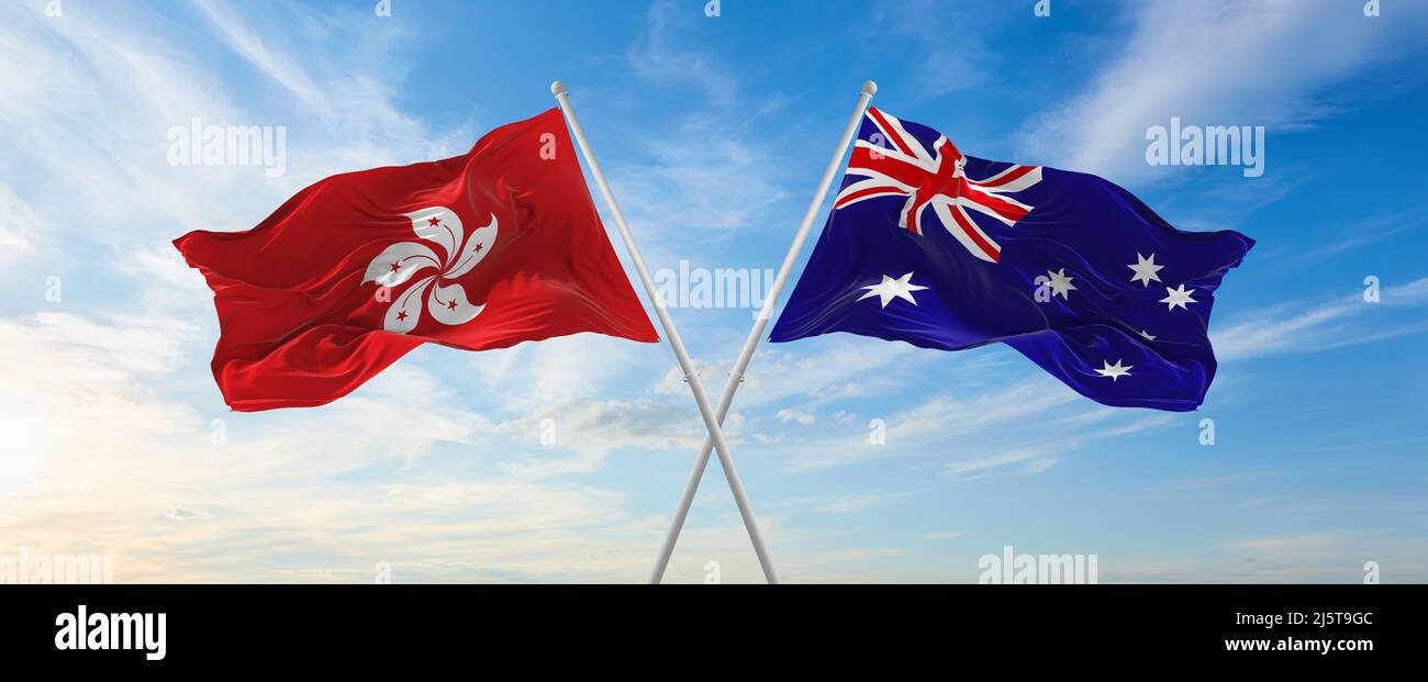 two crossed flags Hong Kong and Australia waving in wind at cloudy sky. Concept of relationship, dialog, travelling between two countries. 3d illustra Stock Photo