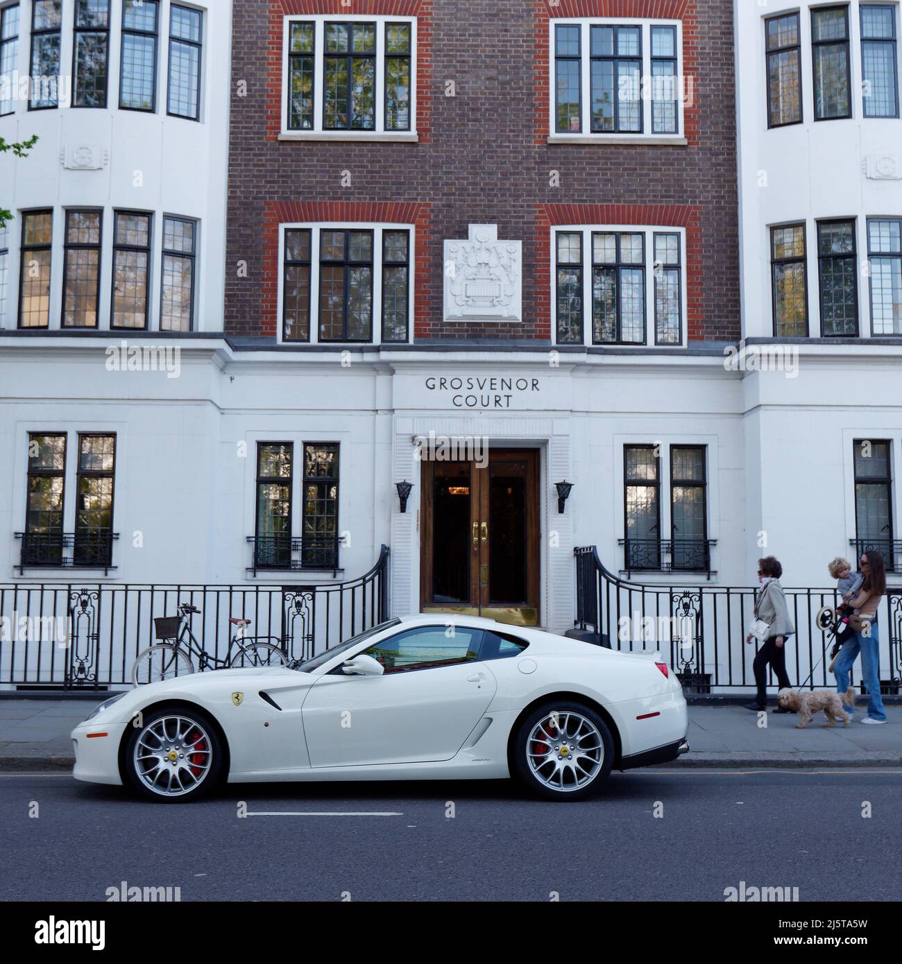 London, Greater London, England, April 16 2022: White Porsche car outside of Grosvenor Court on Sloane Street in the Kensington and Chelsea area. Stock Photo