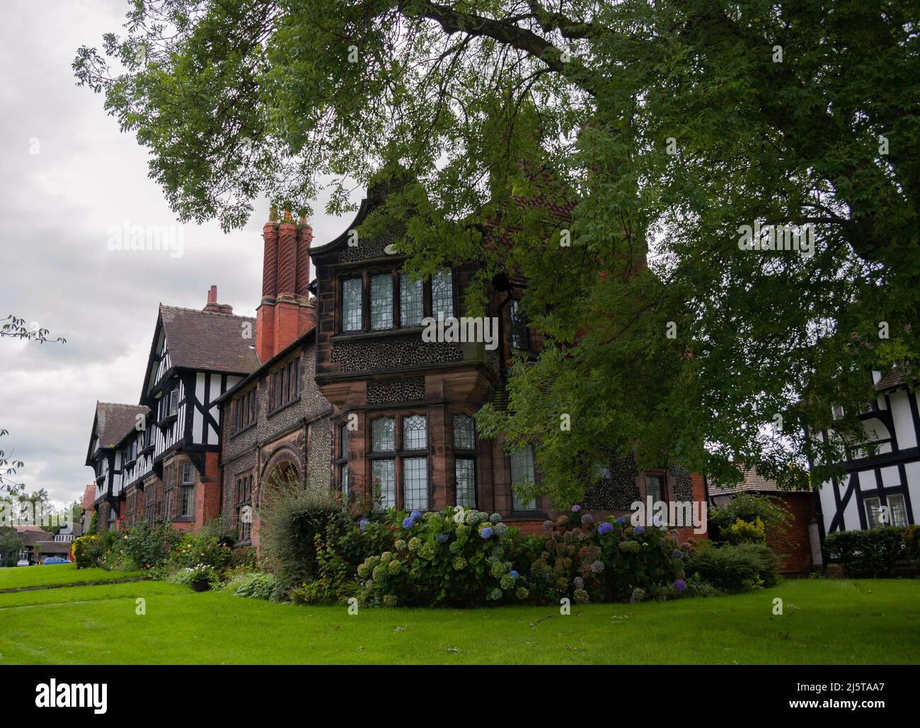 Arts and crafts style houses in garden village of Port Sunlight, Birkenhead, Wirral, United Kingdom Stock Photo