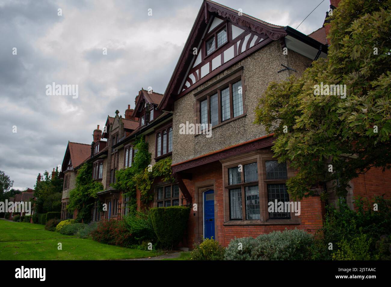 Arts and crafts style houses in garden village of Port Sunlight, Birkenhead, Wirral, United Kingdom Stock Photo