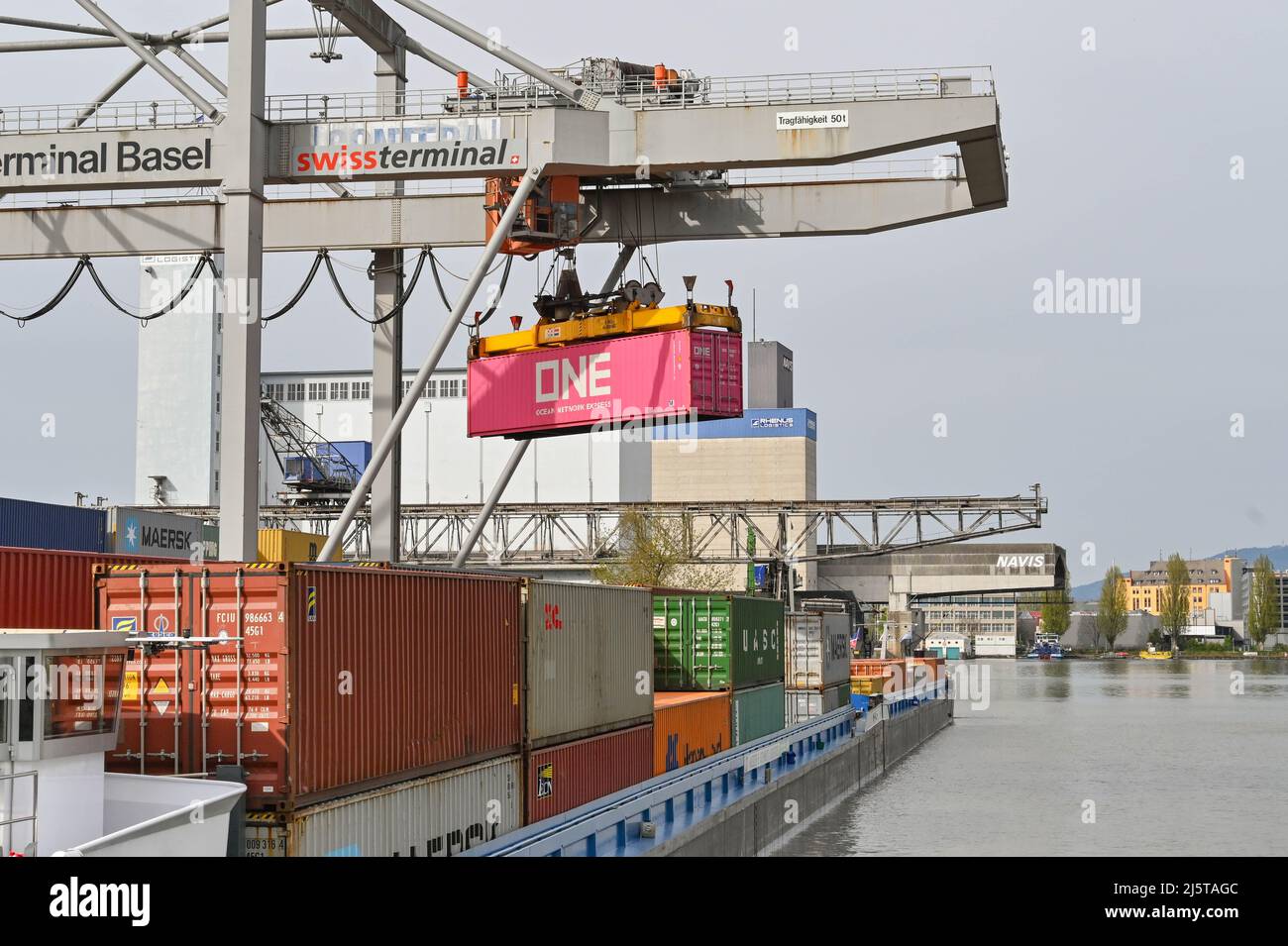 Basel, Switzerland April 2022 Heavy crane in the city's container terminal unloading an