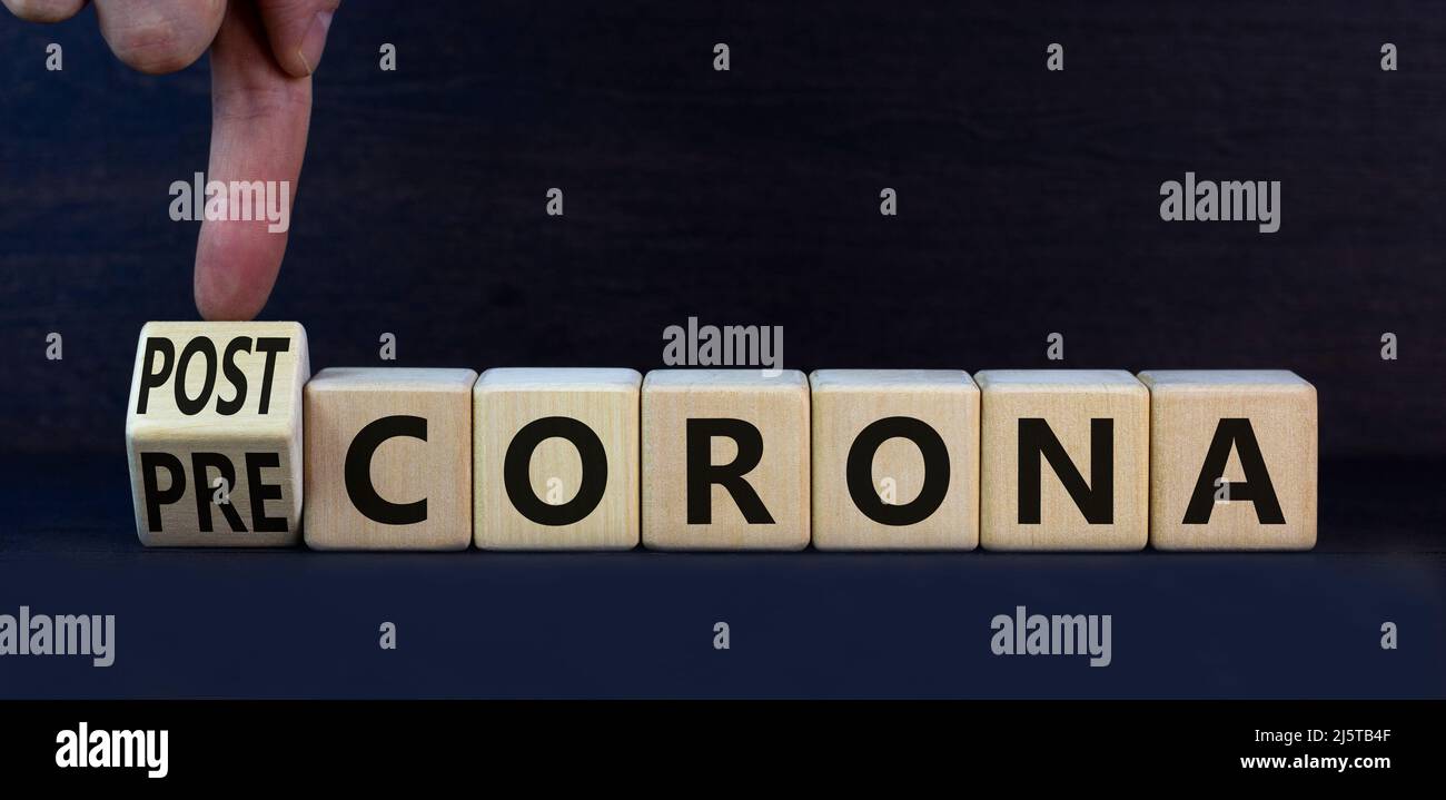 Covid-19 post or pre corona symbol. Turned wooden cubes and changed concept words Pre corona to Post corona. Beautiful grey background. Covid-19 pande Stock Photo