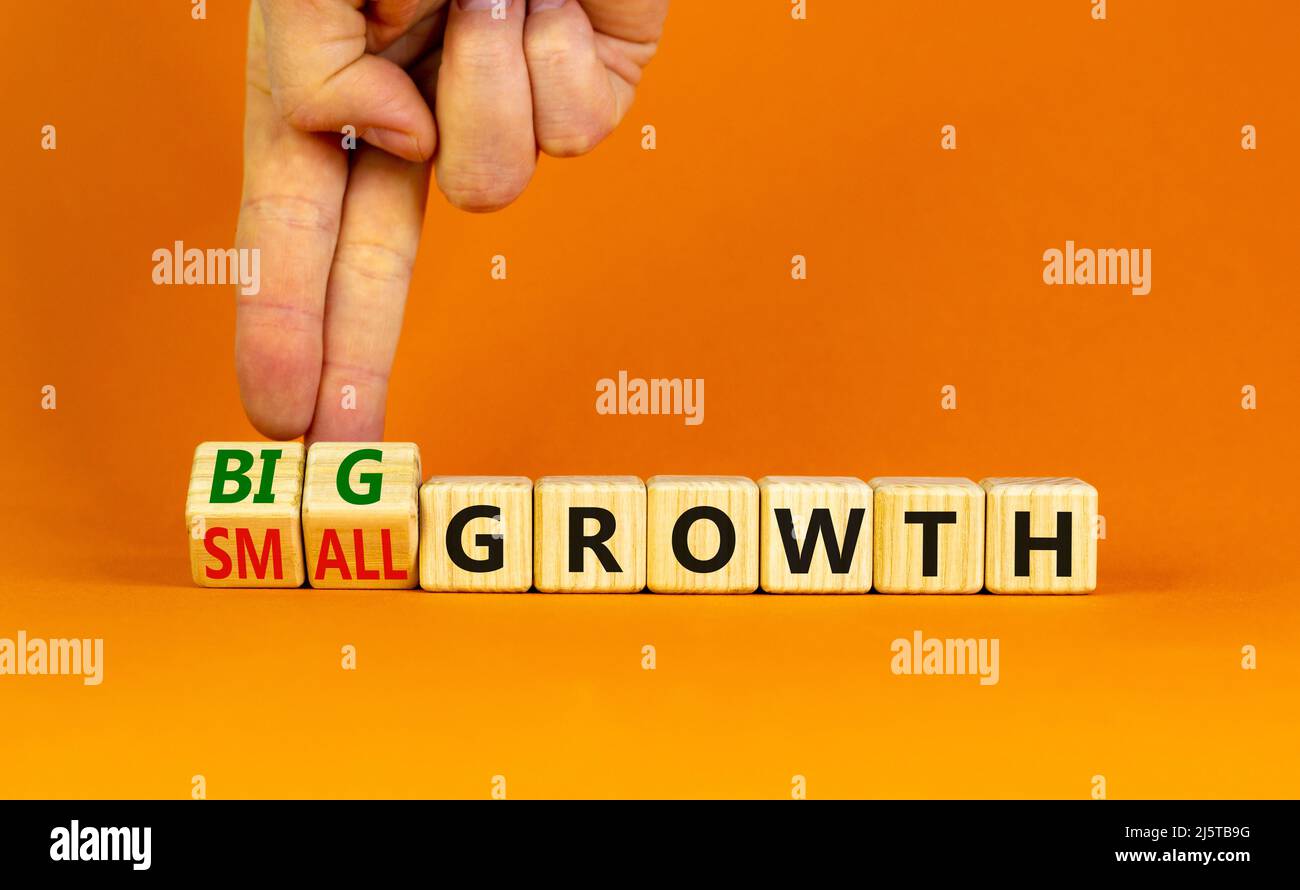 Big or small growth symbol. Businessman turns wooden cubes and changes ...