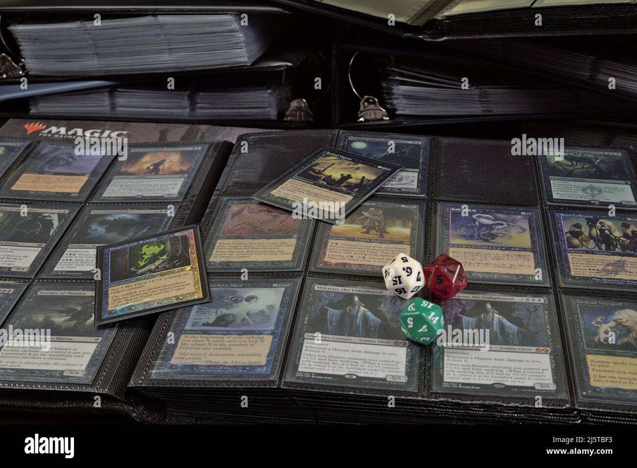 Wroclaw, Poland - February 25 2022: Browsing a large collection of magic the gathering cards - deck construction before friday night magic tournament Stock Photo