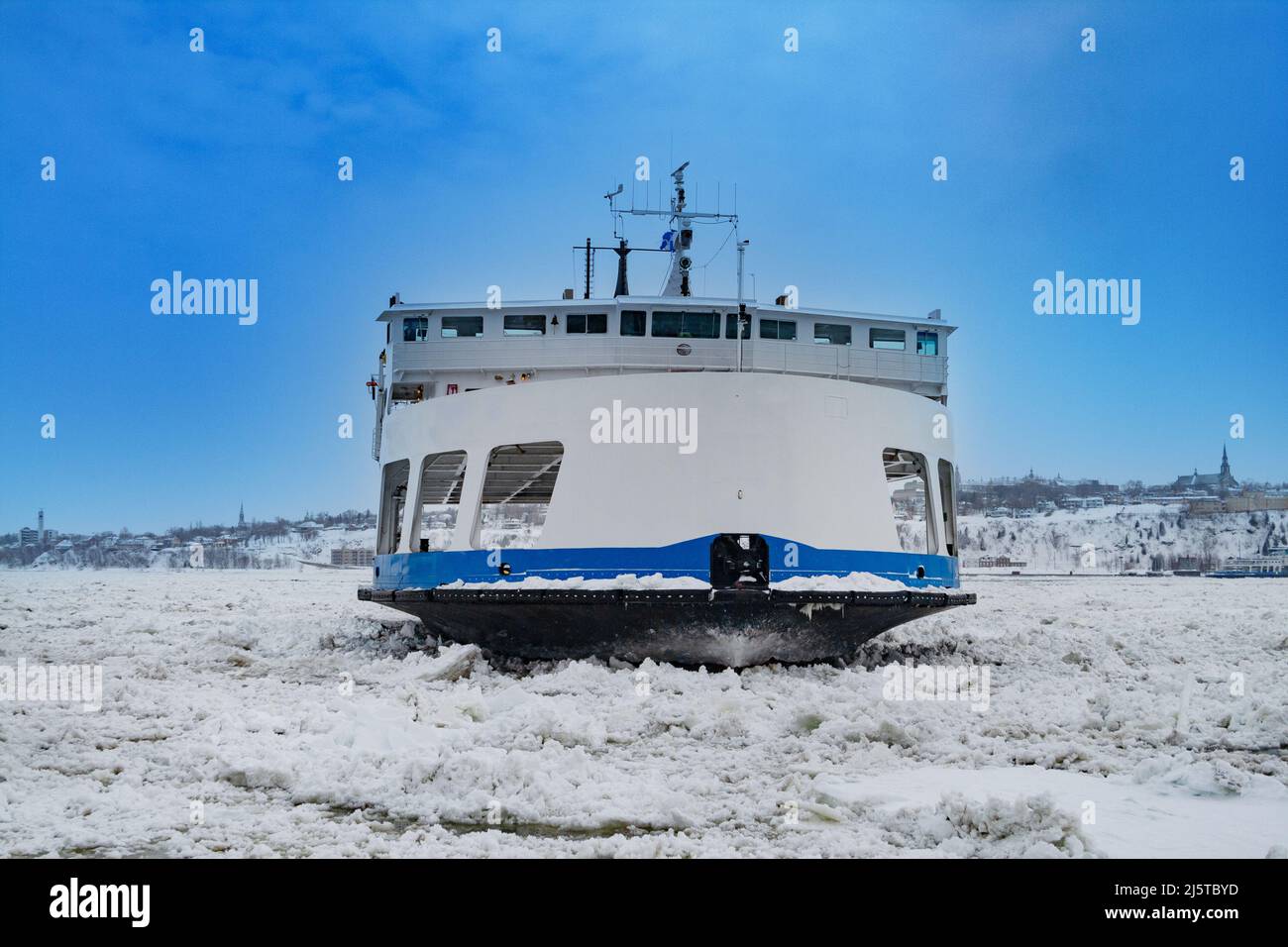 Ship ferry going through ice and snow in the harbor Stock Photo